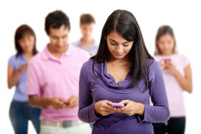 Group of young people texting on their mobile phones